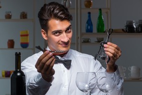 Person holding wine bottle openers